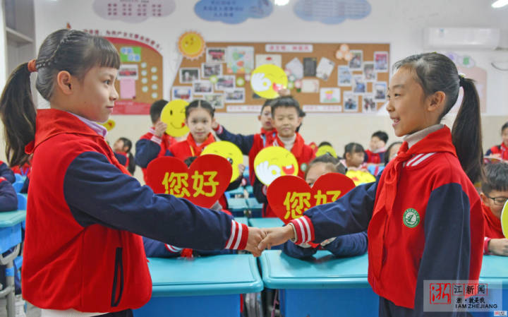 学生在课堂上向同学握手问好.